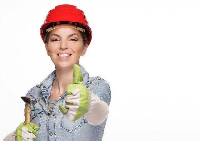 Construction worker, specialist lady with tool and hard hat